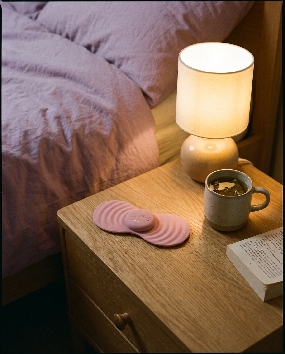 HALO on a bedside table next to a cup of tea
